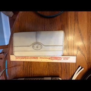 Used cream colored leather fossil wallet